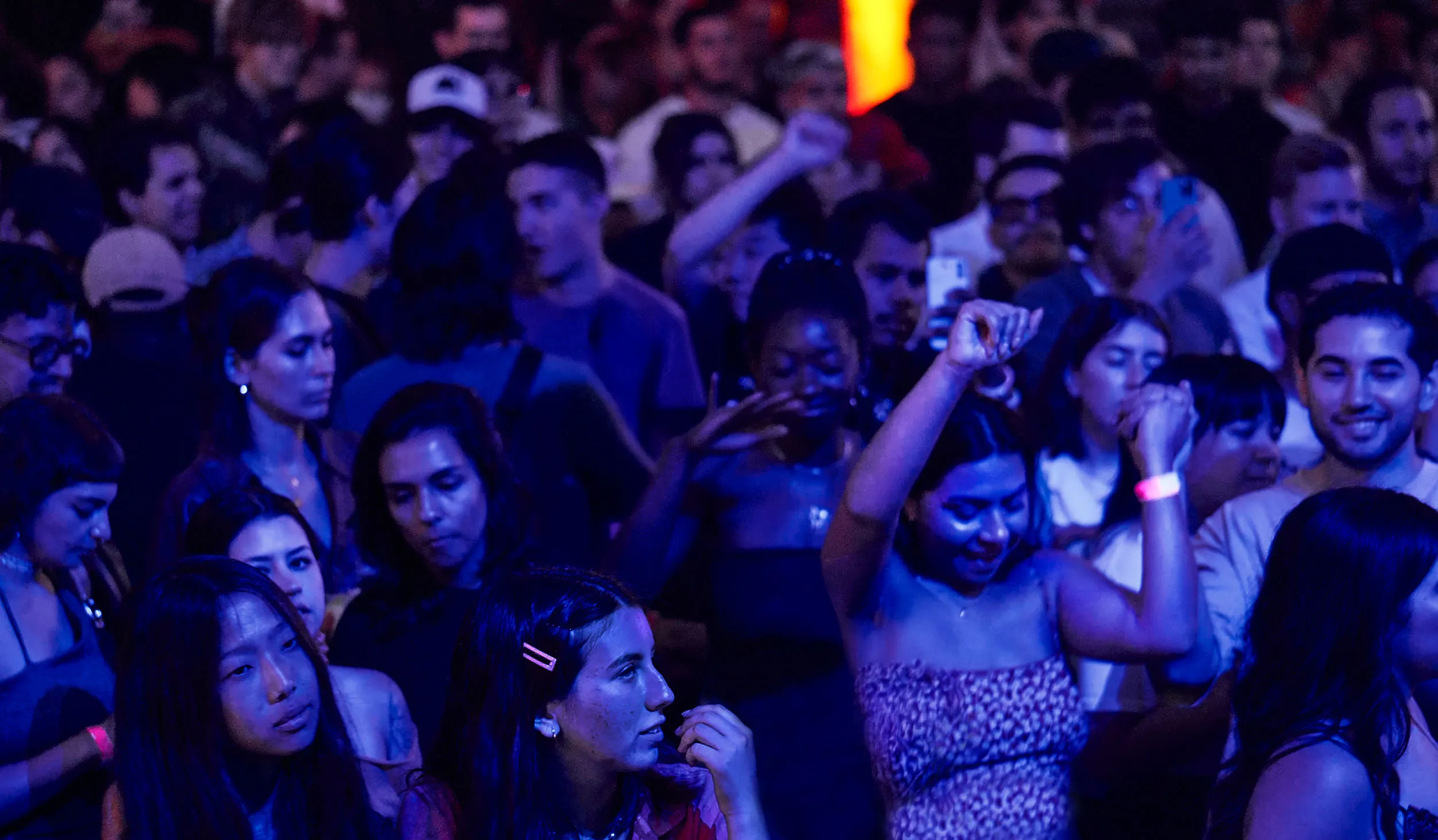 Photo of crowd dancing at an evening event 