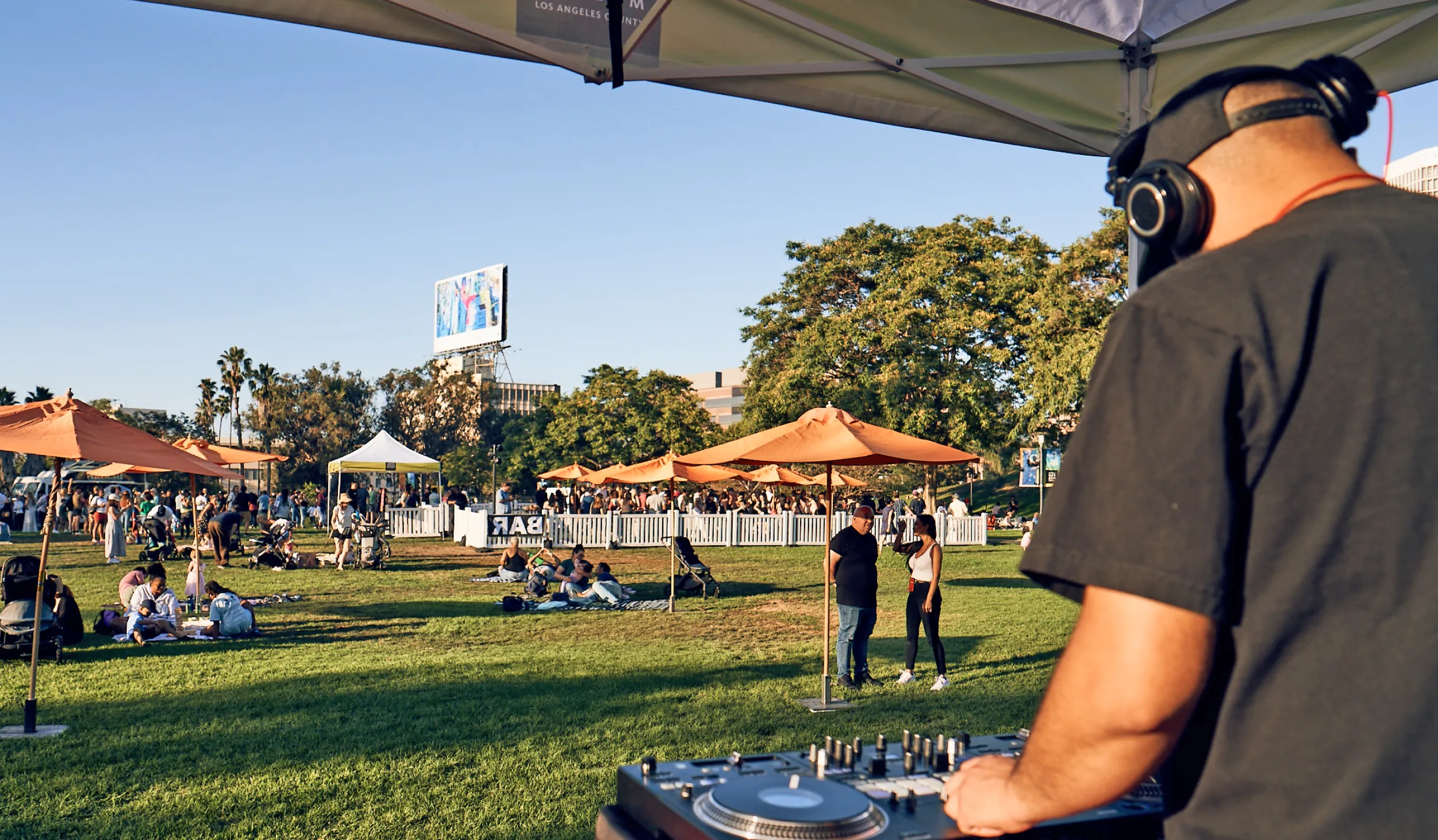 DJ playing to crowd on La Brea Tar Pits park lawn 