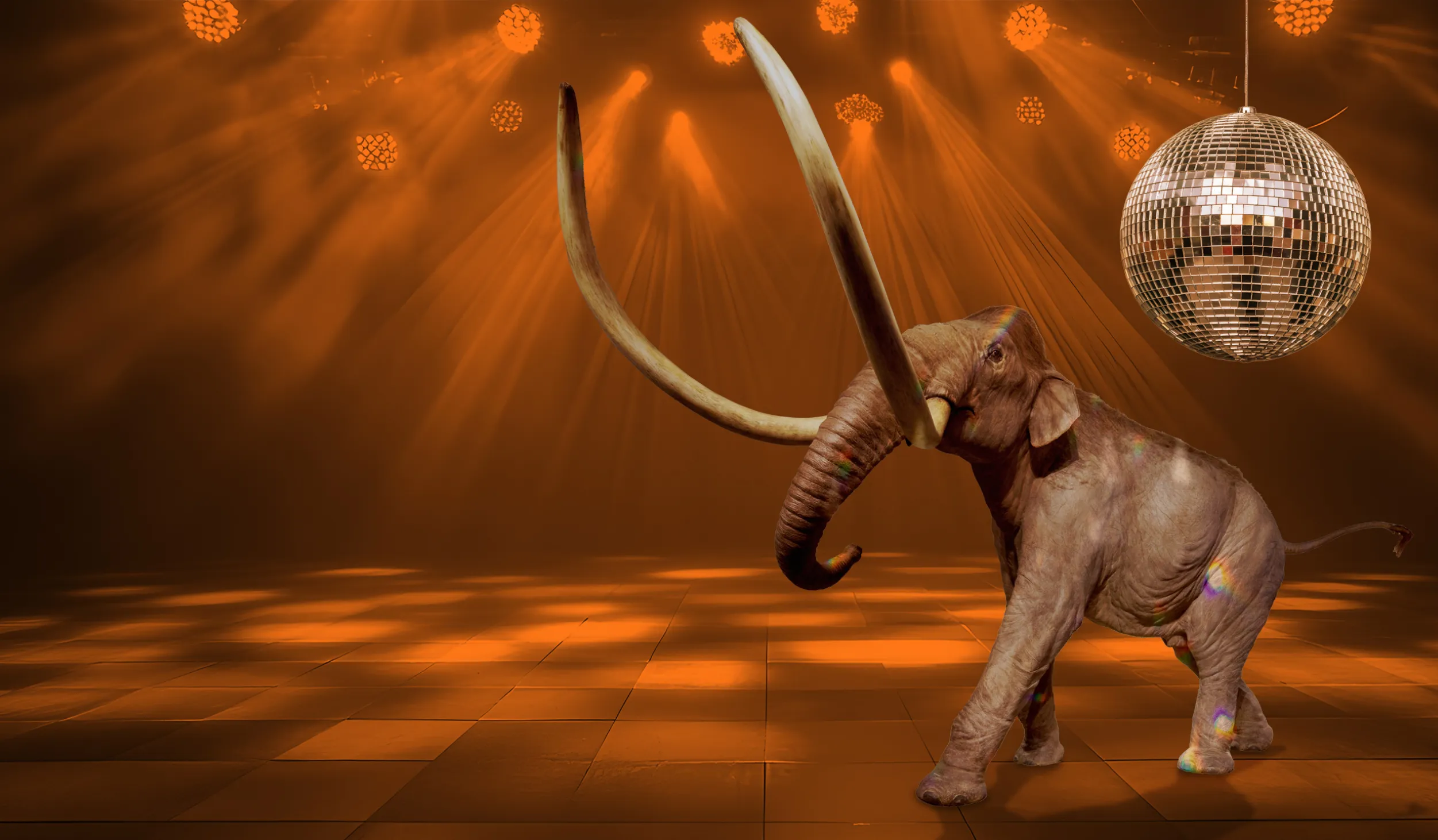 Mammoth sculpture with a disco ball above it, surrounded by orange lighting 