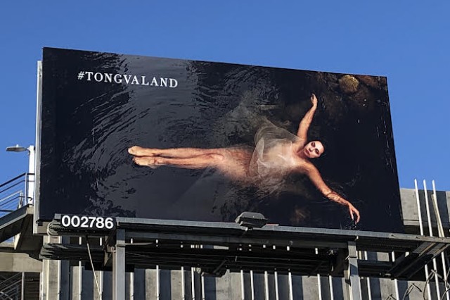 Billboard of woman floating in water 