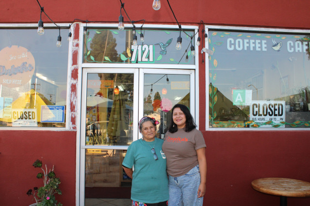 Celina Lopez and her mother Maricruz stand in front of their red building.