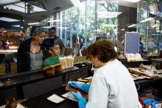 Onlookers watch scientists in the Fossil Lab