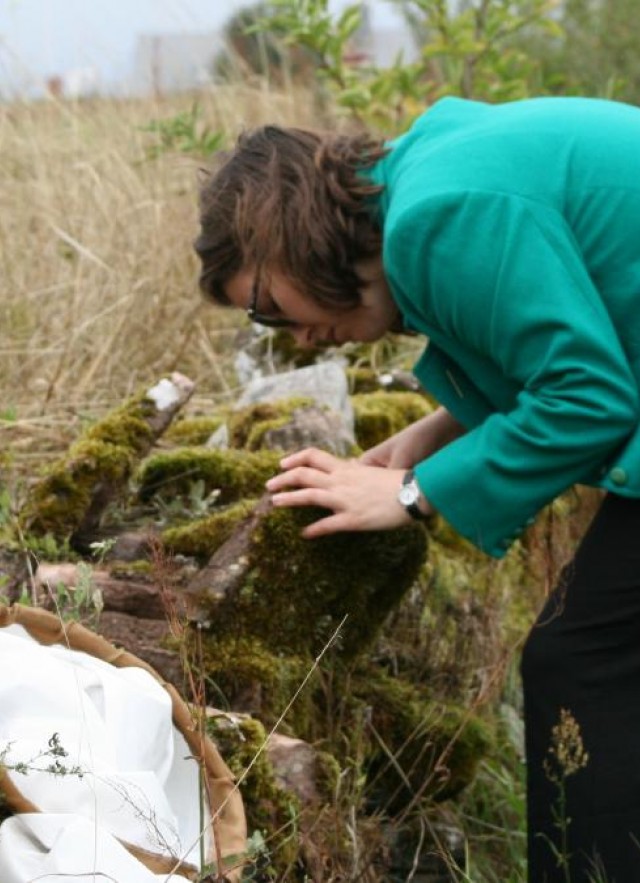 Emily Hartop studying flies on a mossy rock