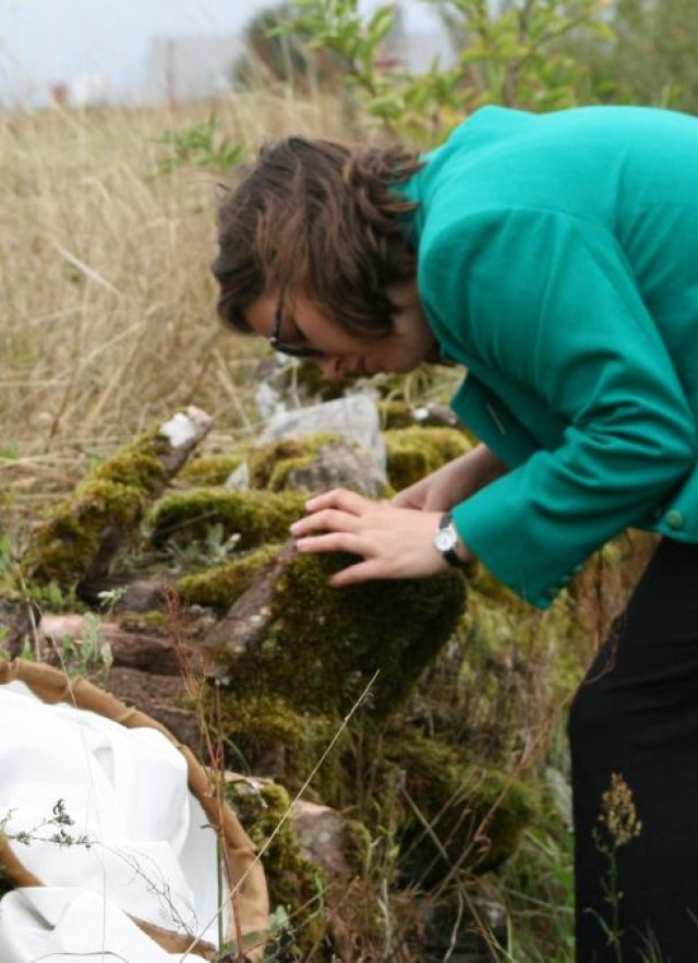 Emily Hartop studying flies on a mossy rock