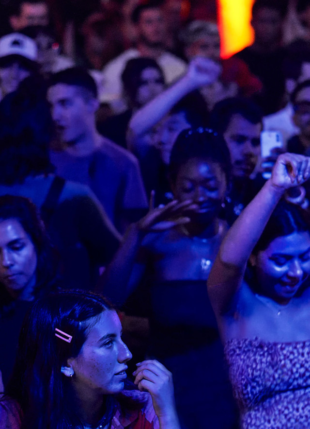Photo of crowd dancing at an evening event 