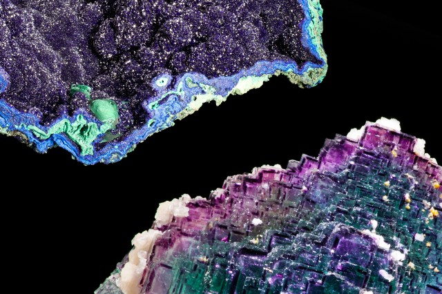 Closeup of two mineral halves, with purple, green, and blue sparkling crystal squares