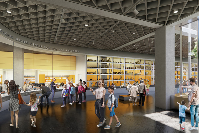 Visitors walking towards a glass-walled laboratory