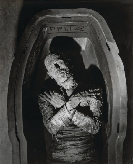 Still image from horror film The Mummy. The Mummy lies in a sarcophagus with arms crossed.