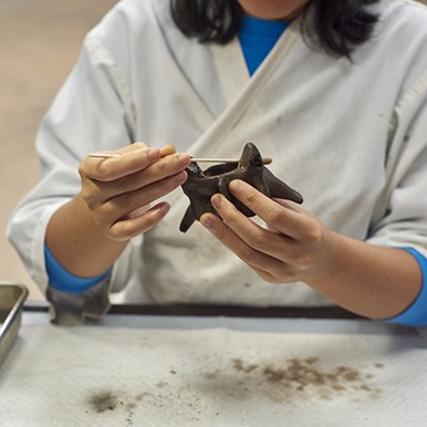 further cleaning of a fossil in the fossil lab at la brea tar pits